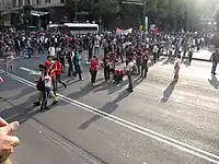 Protesters drawing chalk outlines of human bodies and doves with fake blood on Eje Central