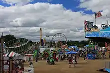 Crowds enjoying an assortment of amusement rides