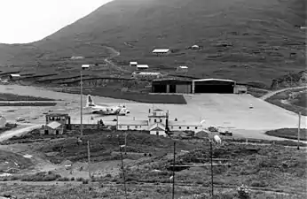 View of Dutch Harbor ramp area with a USCG C-130 Hercules on stand-by for an emergency flight.