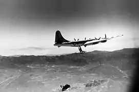 Boeing EB-29 with recovery trapeze deployed for FIghter CONveyer (FICON) trials with McDonnell XF-85 Goblin parasite fighter, seen at bottom