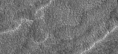 Close up of scalloped ground, as seen by HiRISE under HiWish program. Surface is divided into polygons; these forms are common where ground freezes and thaws. Note: this is an enlargement of a previous image.