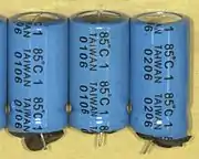 Failed electrolytic capacitors with swollen can tops and expelled rubber seals, dates of manufacture "0106" and "0206" (January and February 2006)