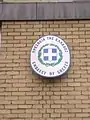 Plaque outside the embassy in English and Greek depicting the Coat of arms of Greece