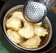 A metal bowl with many small holes.