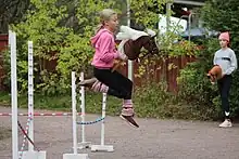 A hobby horse rider jumping