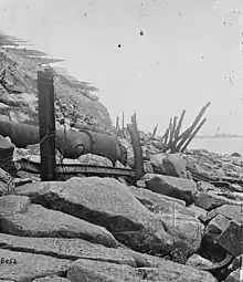 Exterior view of Fort Sumter, 1865.  Banded rifle in the foreground, fraise at the top.