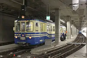 Cream-and-blue train at underground platform