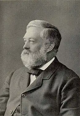 Black and white portrait photograph of Sir Charles Wyville Thomson taken in 2934. He is smartly dressed and has a beard.