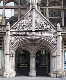 Detail of the entrance to the building, with a carved triangular pediment above the doorways