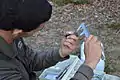 A student measures a superb fairy-wren at Serendip Sanctuary as part of Mulder lab research