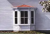 Clapboards around a bay window.