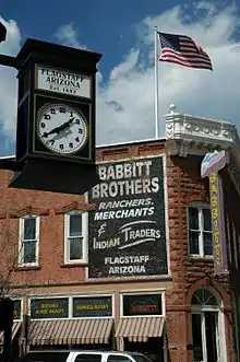 Commercial building with clock in foreground