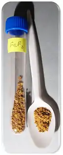 brown powder in a tube and on a spoon