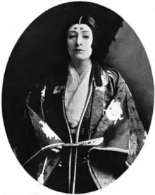 A white woman posing in a Japanese-inspired ensemble