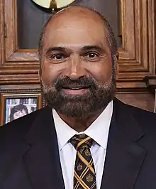 Posed head-and-shoulders photograph of Harris wearing a black tuxedo and black tie