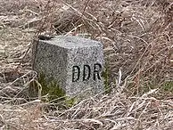 An East German boundary stone with the letters "DDR" (Deutsche Demokratische Republik) carved on the western-facing edge