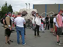 various people standing around a small Flying Spaghetti Monster Parade float.