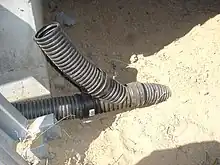 A wye-joining a perforated and solid corrugated pipe to a buried solid outlet