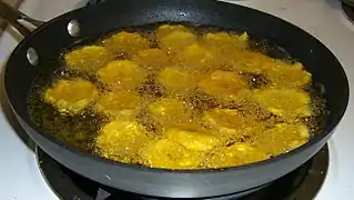 Patacones are twice-fried plantain patties, often served as a side, appetizer, or snack. Here they are being fried for the second time.