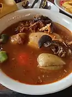 Fufu and light tomato soup with meat