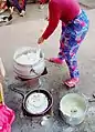 A woman preparing banku in Ghana