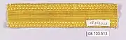 A length of plain, bright gold braid with a zigzag border