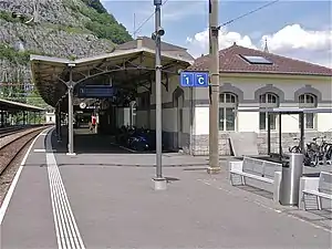 Single-story building with hip roof; canopy-covered platform in front