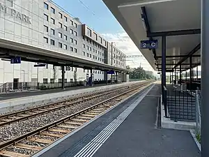 Double-track railway line with side platforms and shelters