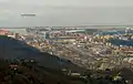 The mouth of the Polcevera; in the background is the Port of Genoa