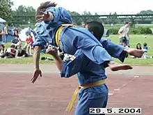 Flying scissors to the neck. The opponent is forced to the ground with a twist of the body.