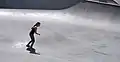 Skatepark with one skateboarder riding