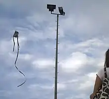 Kite flying in the Philippines, against a gray sky