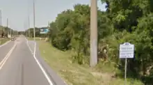 A sign advertises a small Florida community.