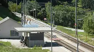 Canopy-covered shelter next to double-track railway line