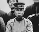 An Asian man in military uniform with a hat.