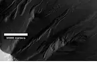 Gullies in Ross Crater, as seen by HiRISE under the HiWish program. Because the gullies are on the narrow rim of a crater and they start at different heights, this example is not consistent with the model of gullies being caused by aquifers.