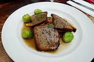 Sliced nut roast with brussels sprouts