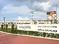 The Shinkansen Station with HAWKS Baseball Park Chikugo. An 800 Series train on a Tsubame service passing through the station is on the back.