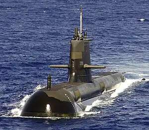 A large submarine travelling on the surface of the ocean.