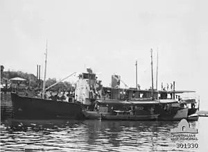 HMAS Southern Cross at Darwin during July 1942. The lugger HMAS Griffioen is moored alongside her