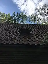 Entrance for bats, fitted in the roof.