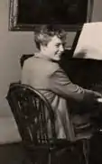 Black and white photograph of Hester Dickson Martineau seated at a piano