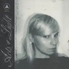 A blurry black-and-white photo of Hilary Woods, with the album title in cursive in a sidebar