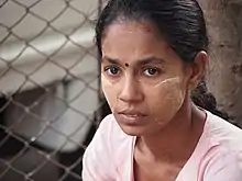 A Burmese Hindu woman wearing thanaka