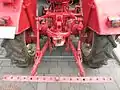 Back of the tractor: Towing hook and linkage. Before a plough can be used, a third arm must be attached to the linkage to gain a three-point linkage.