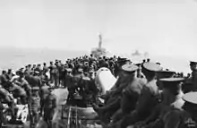 Soldiers standing on the deck of a ship