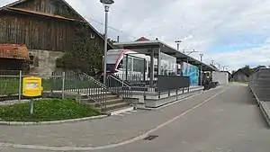 White train at canopy-covered platform