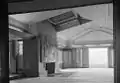 Hollyhock House living room, with fireplace and skylight (toward the southeast, 1965) The fireplace hood features a geometric sculptured relief by Wright.