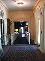 South hallway on the main floor, leading into the living-room, with a view of the Snuggery door to the left