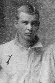 A man in a white baseball jersey.